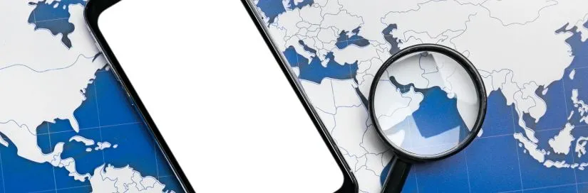 mobile phone, magnifying glass on top of world globe