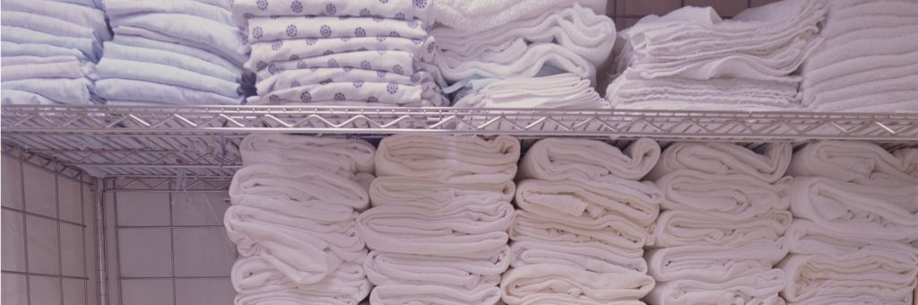 Medical towels freshly folded - commercial-laundry-for-medical-facilities-1024x340
